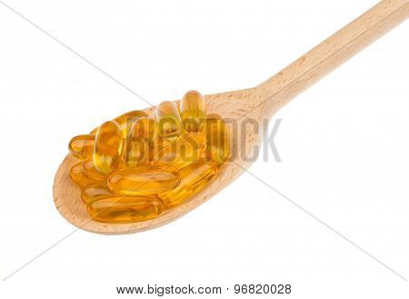 Omega-3 capsules in the spoon isolated.