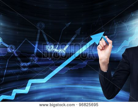 A Hand Is Drawing A Growing Arrow On The Glass Scree, Blue Dark Background With Financial Graphs.