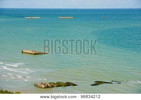 Ruins of harbor built by the Allies in Arromanches, Normandy, France.