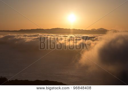 Dramatic Orange Sunset Above The Fog
