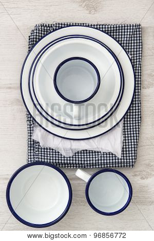 Vintage Enamelware Crockery On Retro Cloths On Rustic Wooden Background