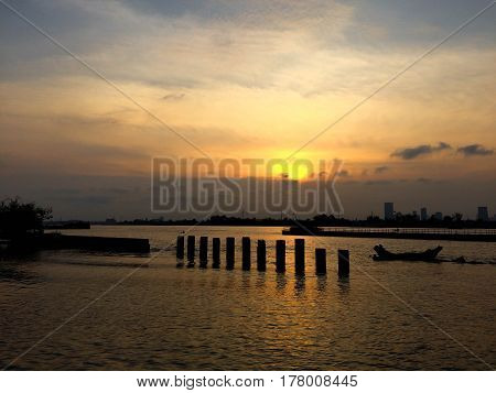 jaophaya river sunset on the lake with cloud and sunlight reflection on a sky and water dark tone of seascape