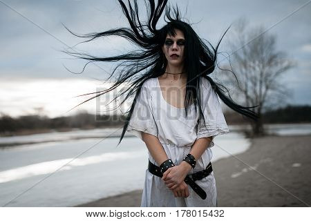 Portrait Of Crazy Young Woman With Hair Blown Up By Wind Near La