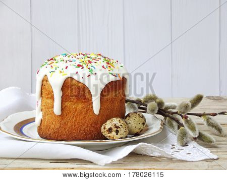 Easter Composition Of Sweet Bread, Paska, Willow Twigs And Eggs On Light Wooden Background. Orthodox