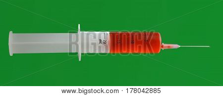 Isolated syringe with needle with red liquid on green background