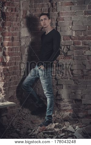 guy in a black sweater in an abandoned building