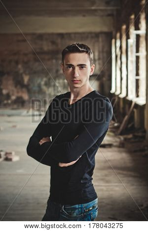 guy in a black sweater in an abandoned building