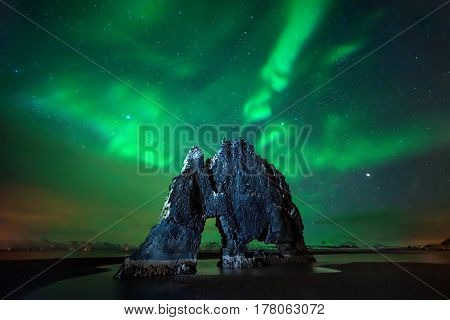Aurora borealis above Hvitserkur rock formation Iceland