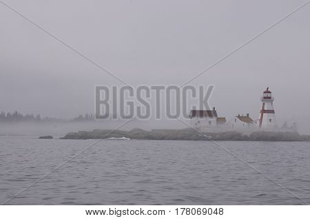 Atlantic coast lighthouse in foggy, rainy weather