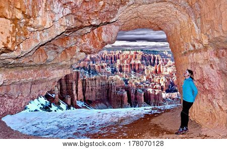 Woman in cave with beautiful view of Bryce Canyon. Bryce Canyon National Park. Moab. Utah. United States.