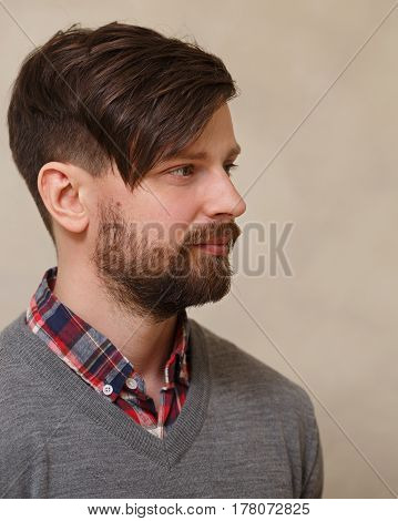 Men's fashion haircut. Beauty saloon. Male beauty. The client is a hipster. An example of a hairdresser's work.
