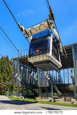Mt. Stanserhorn, Switzerland - 8 May, 2016: a gondola of the Cabrio cable car starting its way to the top of the mountain from the Kalti station. Stanserhorn Cabrio is the the world's first double deck open top cable car.