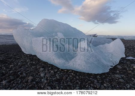 Ice breaking from icebergs on black rock sand beach Iceland natural landscape background