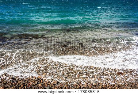 ocean coastline with calm waves and turquoise water