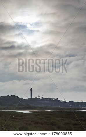 El Rompido lighthouse and marina at sunrise from marshlands Huelva Spain