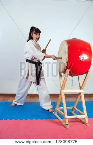 Woman In A Kimono Pounding The Drum