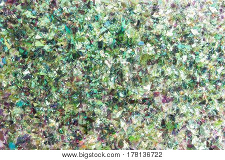 Particle of shattered green glass texture background