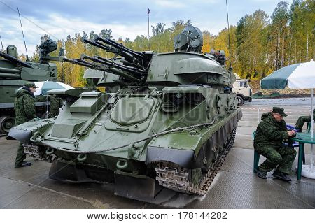 Nizhniy Tagil, Russia - September 26. 2013: Visitors examine military equipment on exhibition range. Antiaircraft gun missile system ZSU-23-4M4 Shilka-M4. Russia Arms Expo-2013