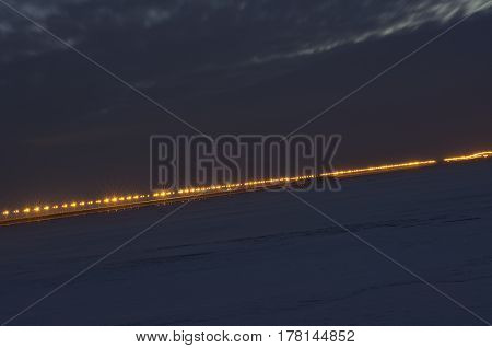 Night highway passing through the dam leading through Kronstadt to St. Petersburg.