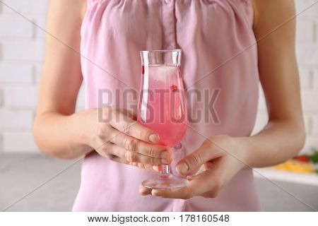 Woman holding glass of delicious wine spritzer