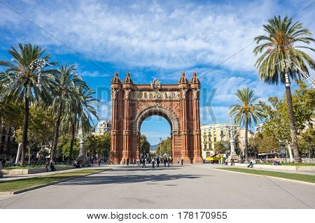 BARCELONA, SPAIN - OCTOBER 22, 2015: The Arc de Triomf is a triumphal arch in the city of Barcelona in Catalonia Spain. The arch is built in reddish brickwork in the Neo-Mudejar style