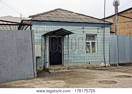 Facade of an old building with a tile on the wall