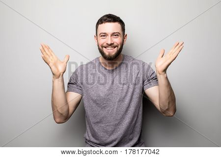 Portrait Of Happy Man Rise Up Hands And Successful Achievement Of Goals On Grey