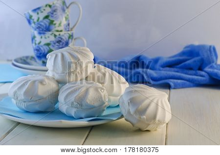White vanilla marshmallows in a plate on a white background