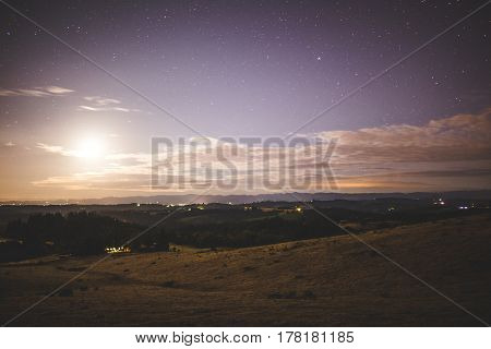 Bright Moon In Night Sky Over Rural Farm Land