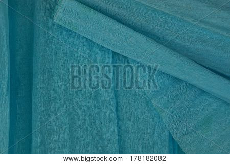 Blue background of a roll of crumpled paper