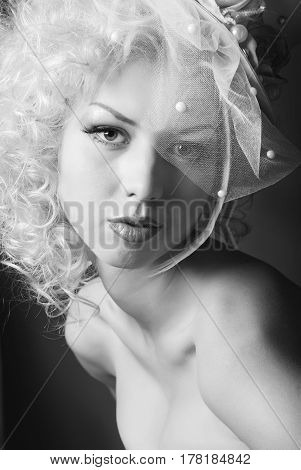 black and white portrait of a sensual girl in a hat with a veil