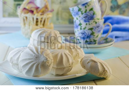 White vanilla marshmallows in a plate on a white background