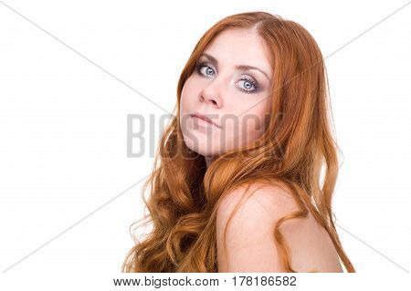 studio portrait of pretty redhead girl on a light background.
