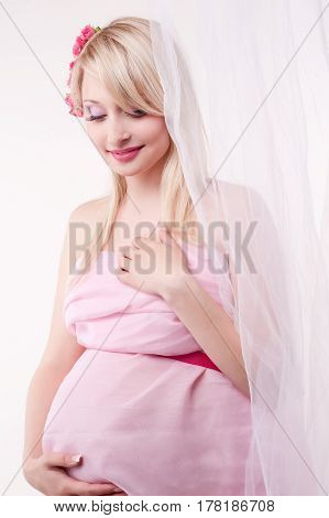 Photo portrait of a lovely young pregnant woman in a photo studio.