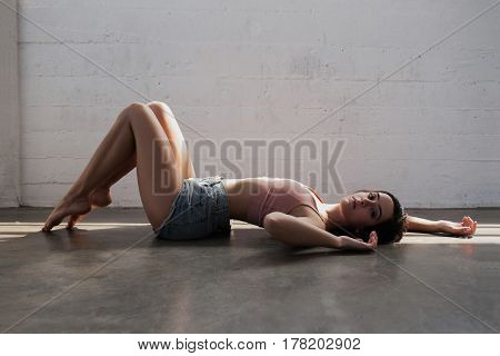 Sexy young woman is laying on the floor