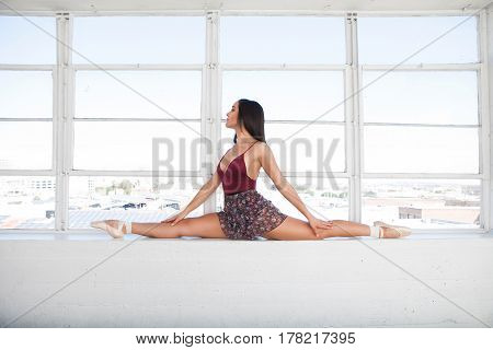 Beautiful talented flexible woman doing the split