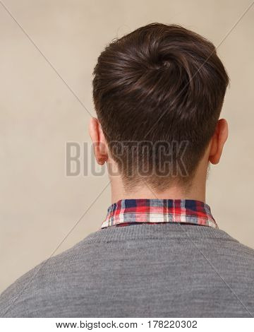 Men's fashion haircut. Beauty salon. Male beauty. The client is a hipster. An example of a hairdresser's work.