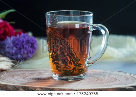 Cup Of Tea With Thyme And Bouquet Of Flowers On Background. Spring Concept