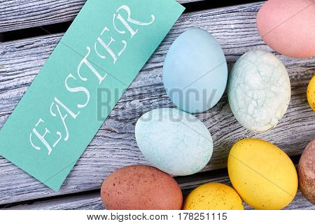 Dyed chicken eggs. Easter crafted card. Easter holiday mirth.