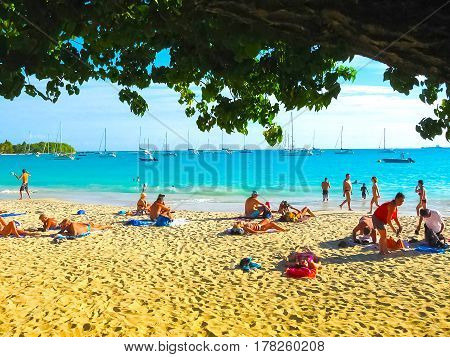 Saint Francois, Guadeloupe - February 09, 2013: The people resting at Anse Champagne beach in Saint Francois, Guadeloupe, Caribbean on February 09, 2013
