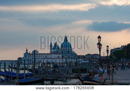 Gondola Station With Tourists At Dusk. Venice