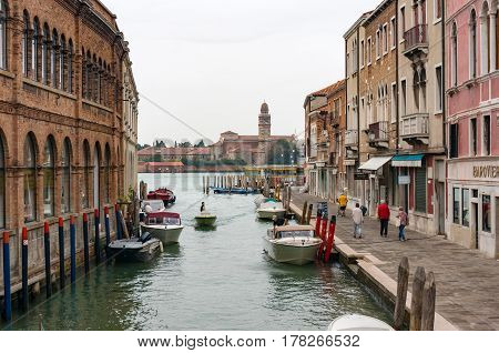 Murano Canal With Old Building And People. Italy