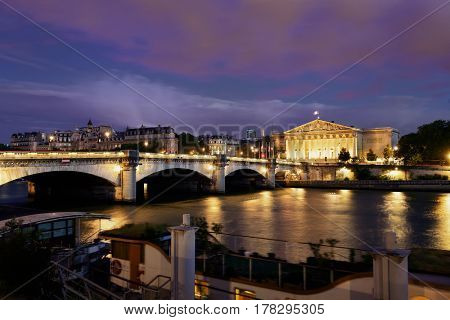 Paris River Seine with Pont de la Concorde and Assemblee Nationale at dusk