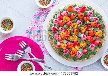 Buttercream flower tulip cake beautiful festive cake decorated with colorful cream flowers for spring holidays
