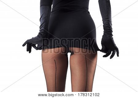 Sexy female legs in beautiful stylish stockings and high heels shoes black gloves and dress isolated on white background horizontal view