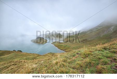 alpine lake in dence fog Schrecksee Germany
