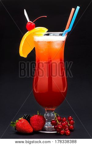 red cocktail with straw on black background