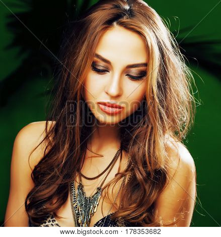 young cute blonde woman on green palm background smiling happy, lifestyle peole concept close up