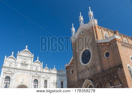 The Basilica di San Giovanni e Paolo (brick building) and The Scuole Grandi (marble building) in Venice (Italy)