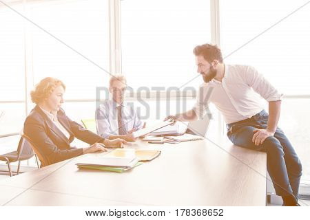 Toned of handsome man offering his CV for investigation of his experience. Businessman explaining employees about his previous companies he worked in.